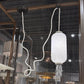 White textured pendant light hanging from a ceiling with a blurred indoor background