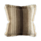 A square throw pillow with a shaggy, faux-fur texture and fringed edges, featuring vertical stripes in cream, beige, and dark brown on a white background.