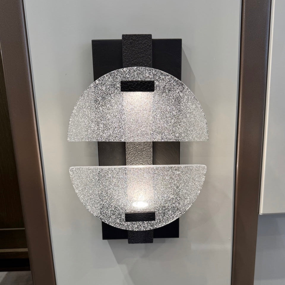 Decorative wall sconce with crystal-like design on a neutral background