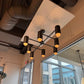Modern chandelier hanging in a room with large windows