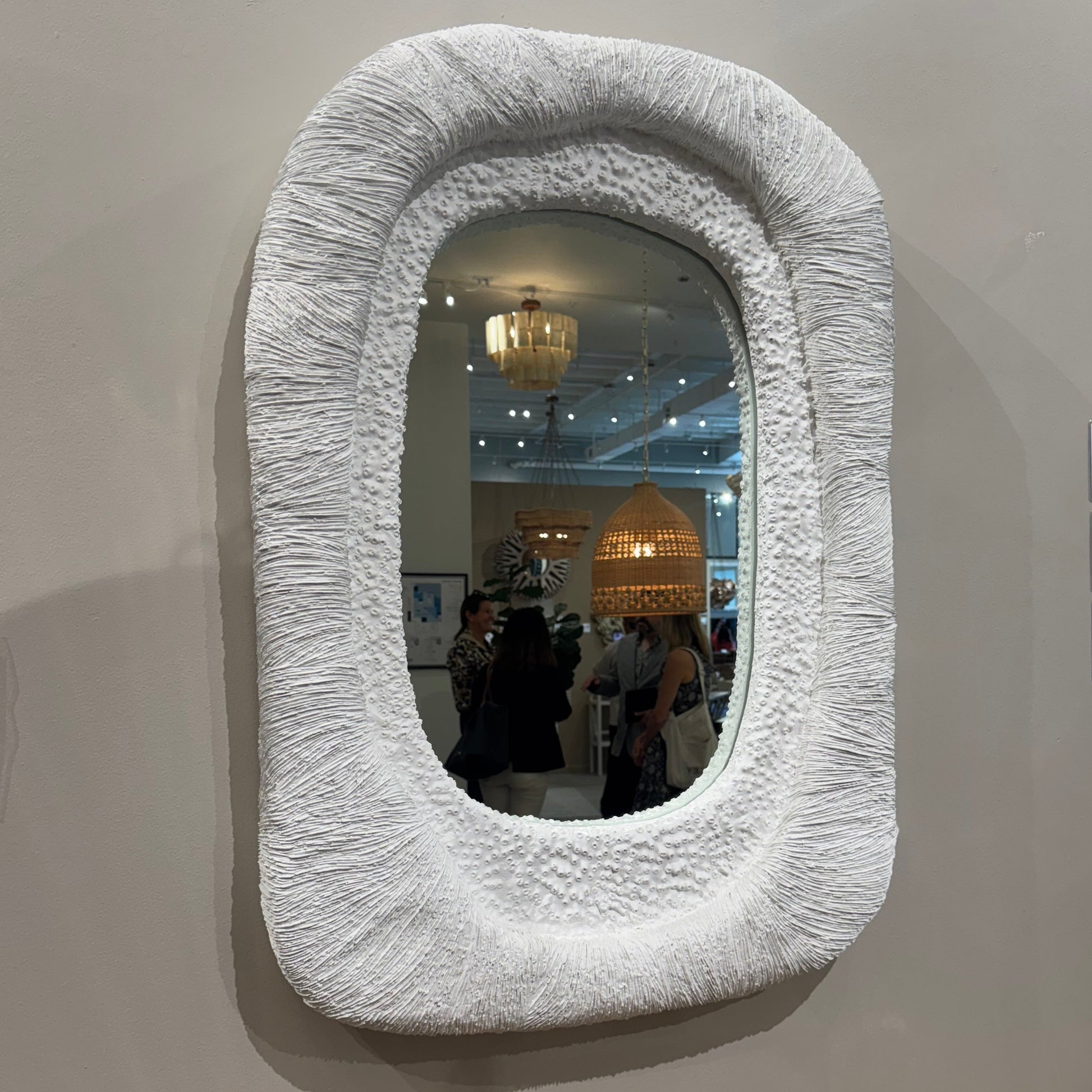 Decorative mirror with textured frame on a wall