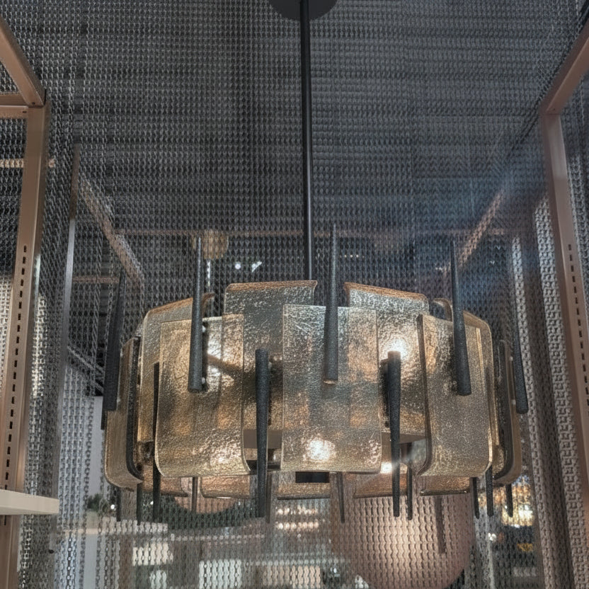 Decorative chandelier hanging from a ceiling with a metallic grid structure.
