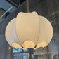 Beige pendant light fixture hanging from a ceiling
