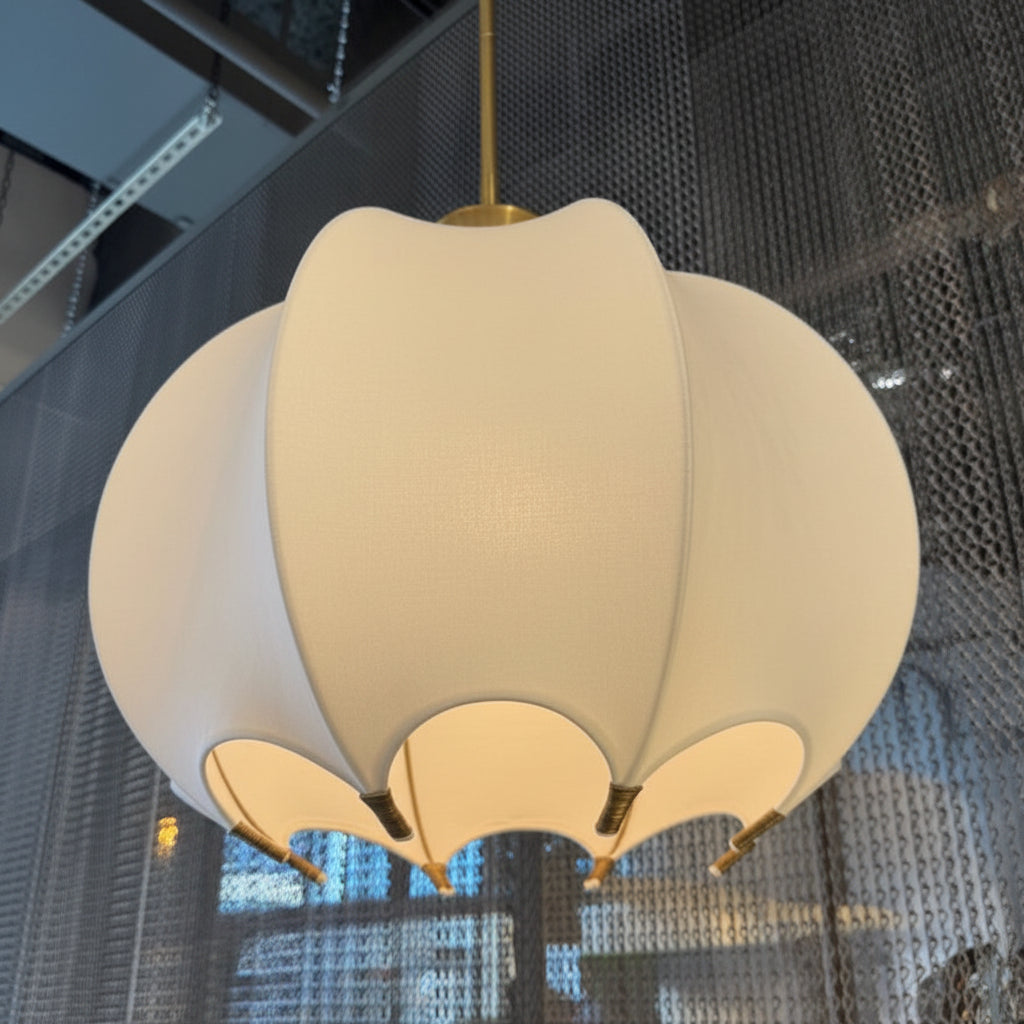 Beige pendant light fixture hanging from a ceiling