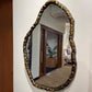 Decorative mirror with a gold frame on a wall