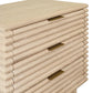 Wooden side table with three drawers and brass handles on a white background