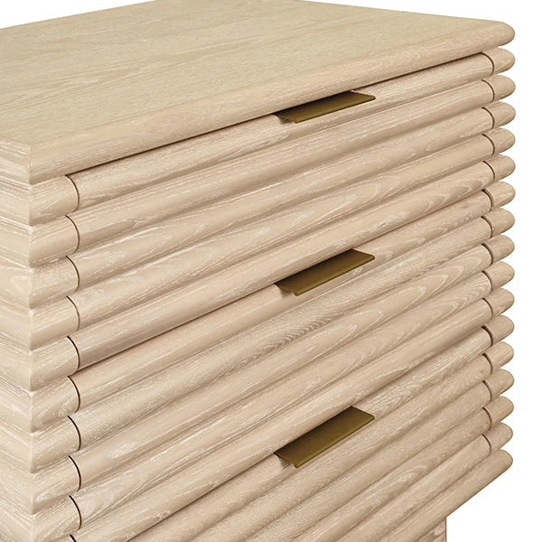 Wooden side table with three drawers and brass handles on a white background