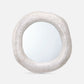 Round mirror with a textured white frame on a light gray background