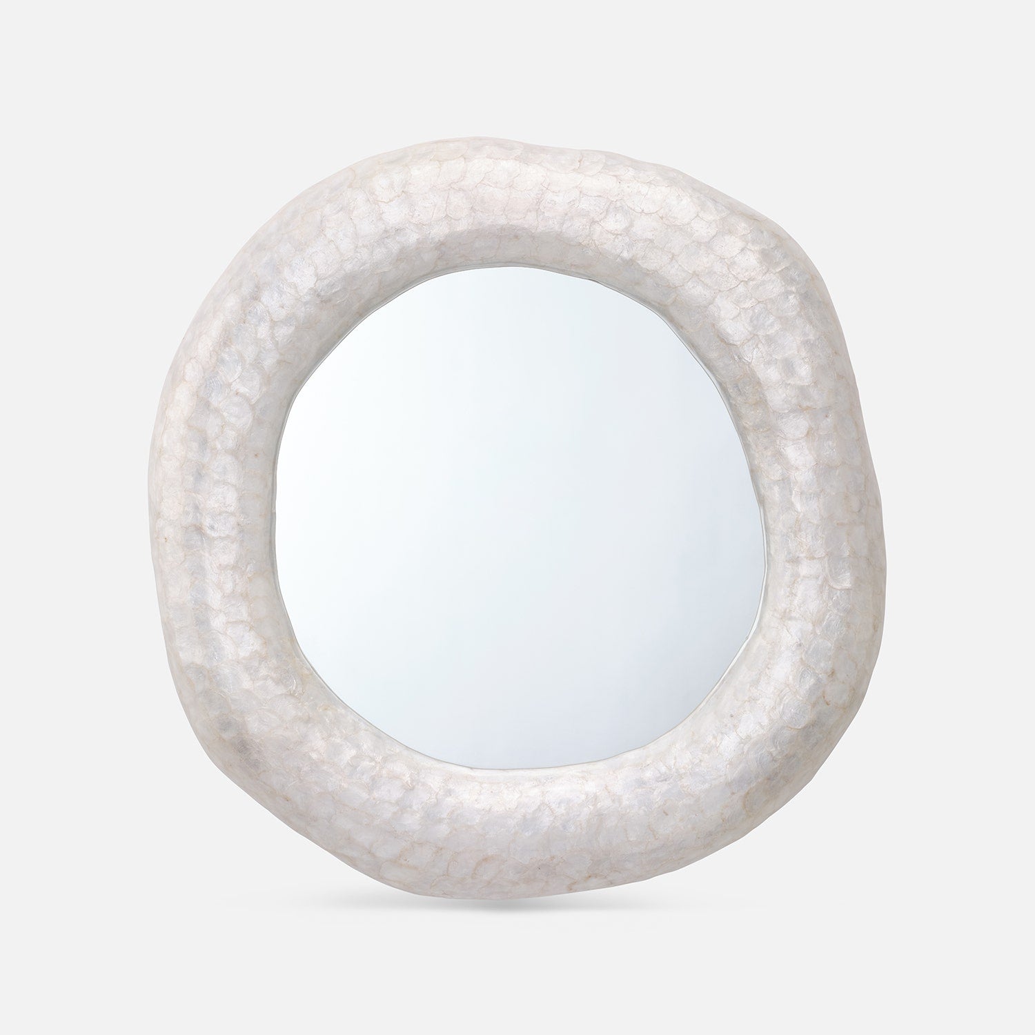 Round mirror with a textured white frame on a light gray background