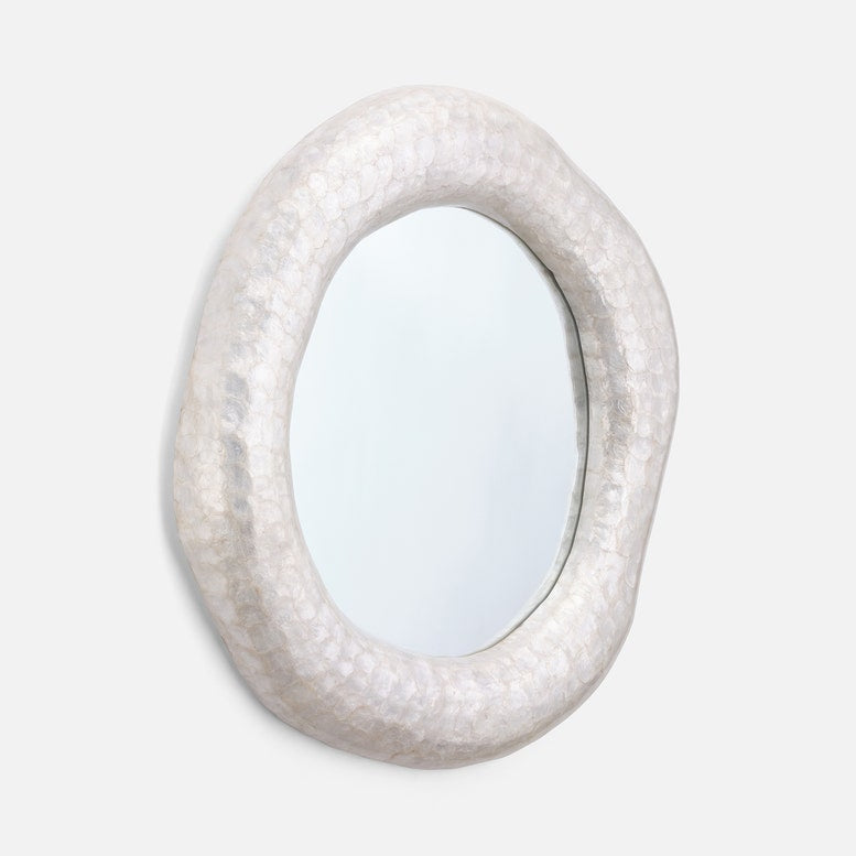 Decorative mirror with a textured, off-white frame on a light gray background