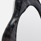 Close-up of a carbon fiber product on a white background
