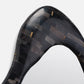 Close-up of a black and gray patterned object on a white background