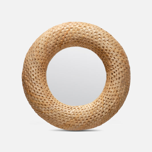 Round woven mirror with natural wood finish on a light gray background