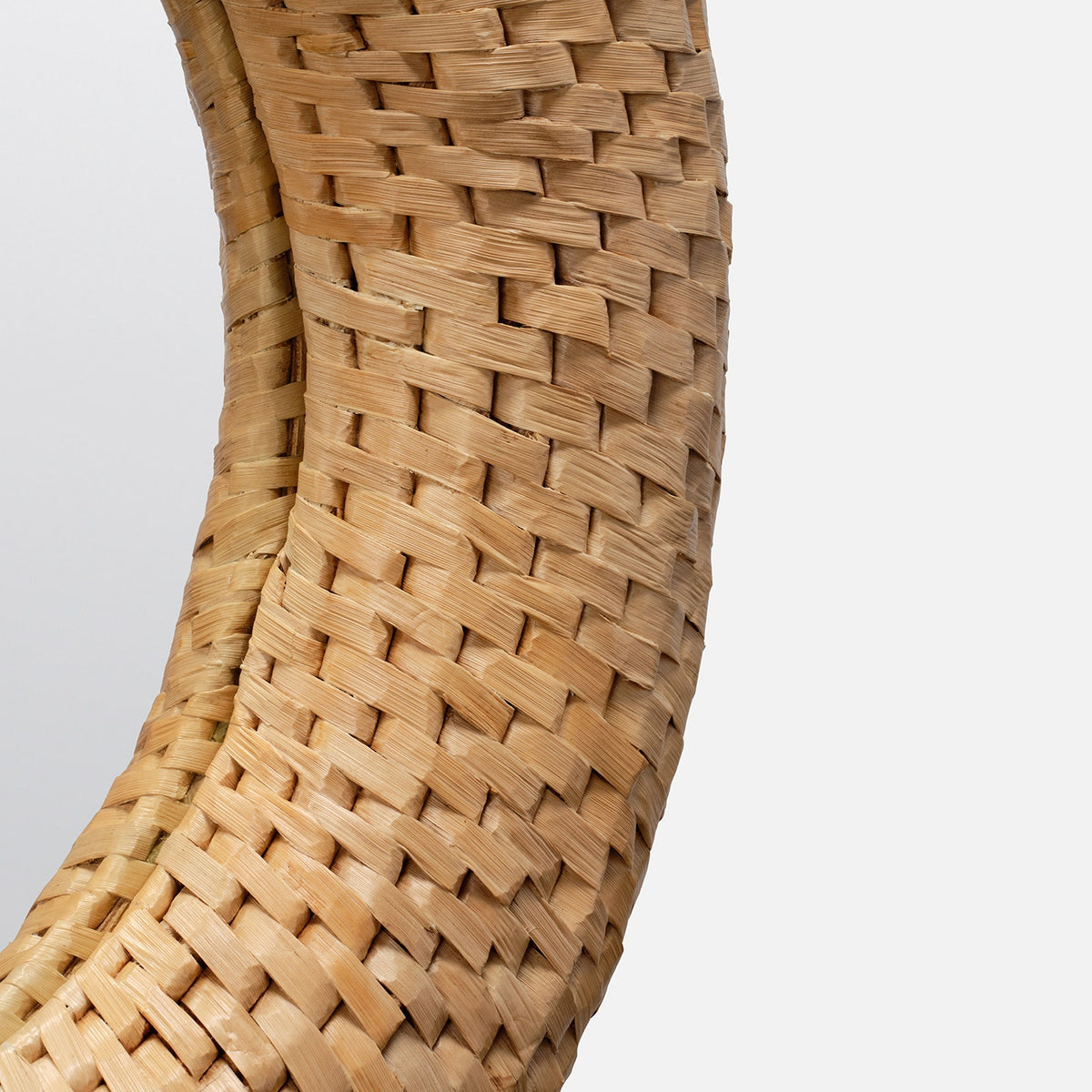 Close-up of a woven basket on a light gray background