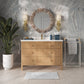 Bathroom with wooden vanity, round mirror, and decorative elements.