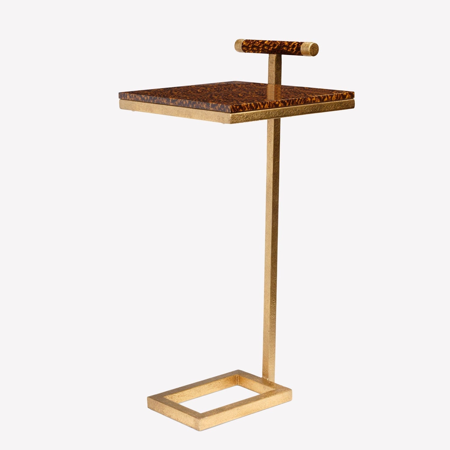 Small side table with tortoiseshell top and gold base on a white background