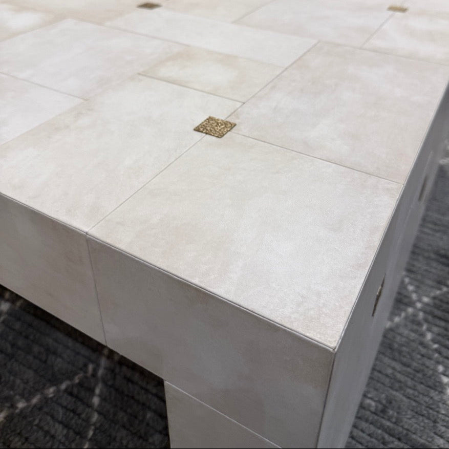 White tiled table with a blurred background of furniture