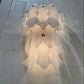 Decorative wall light fixture casting a soft glow on a marble wall.