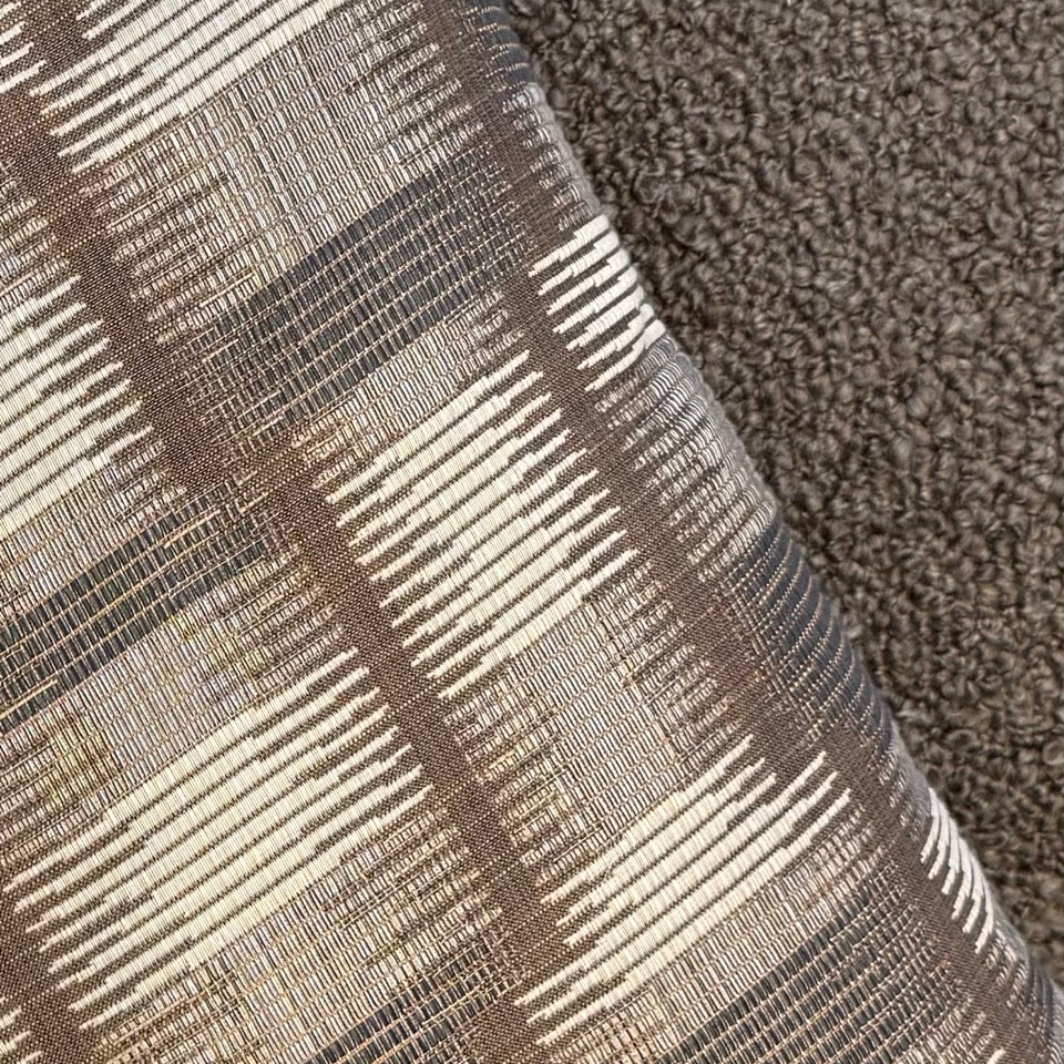Textured fabric with a checkered pattern on a brown carpet
