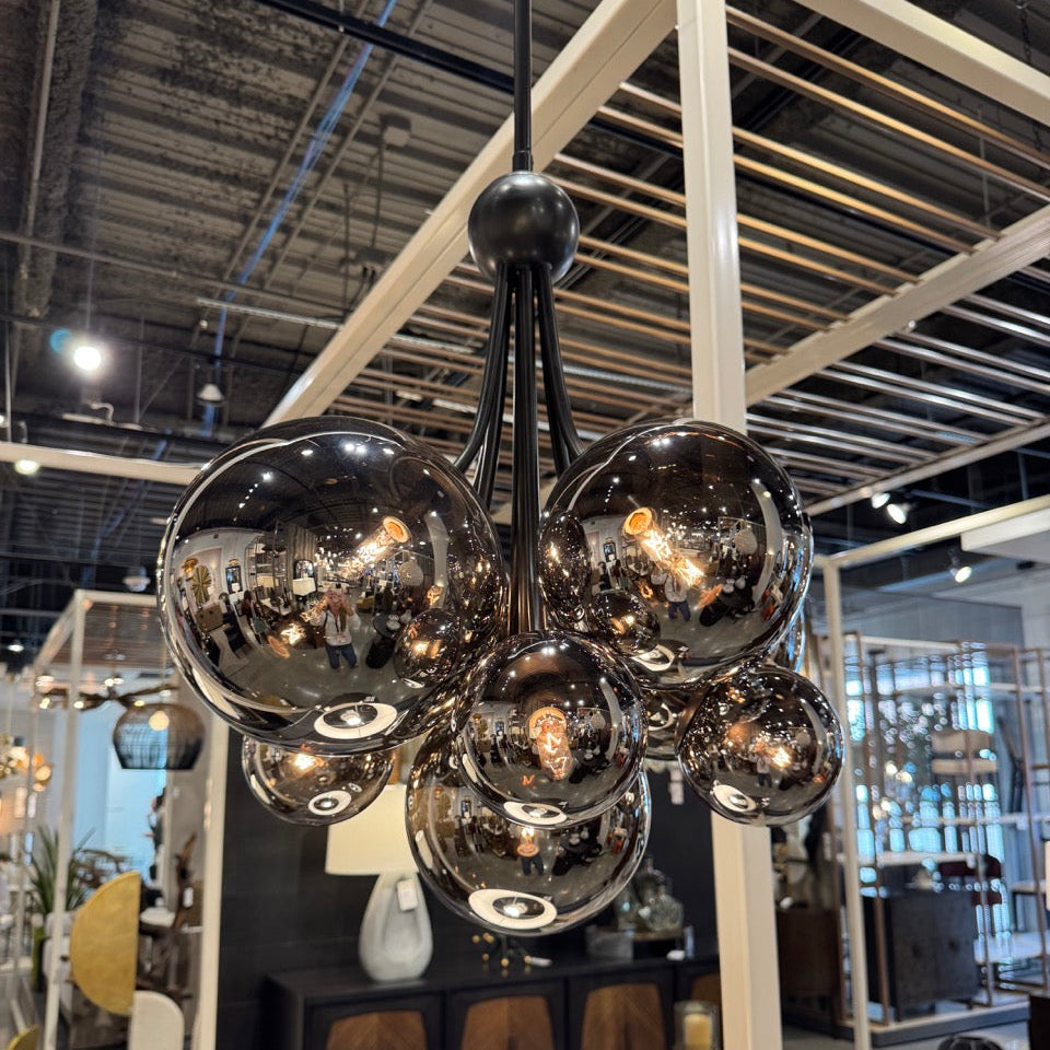 Modern chandelier with glass spheres in a showroom setting