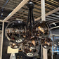 Modern chandelier with reflective glass spheres in a store setting