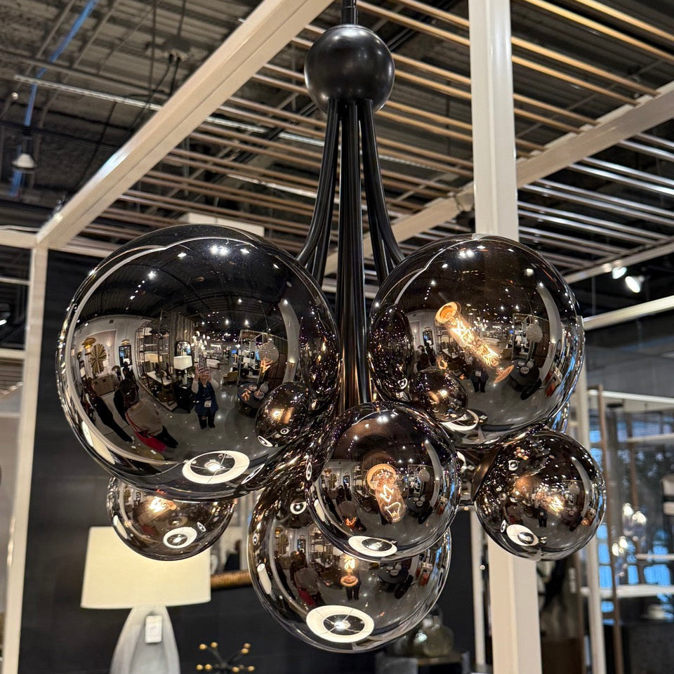 Modern chandelier with reflective glass spheres in a store setting