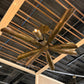 Bronze ceiling fan mounted on a wooden ceiling with exposed beams