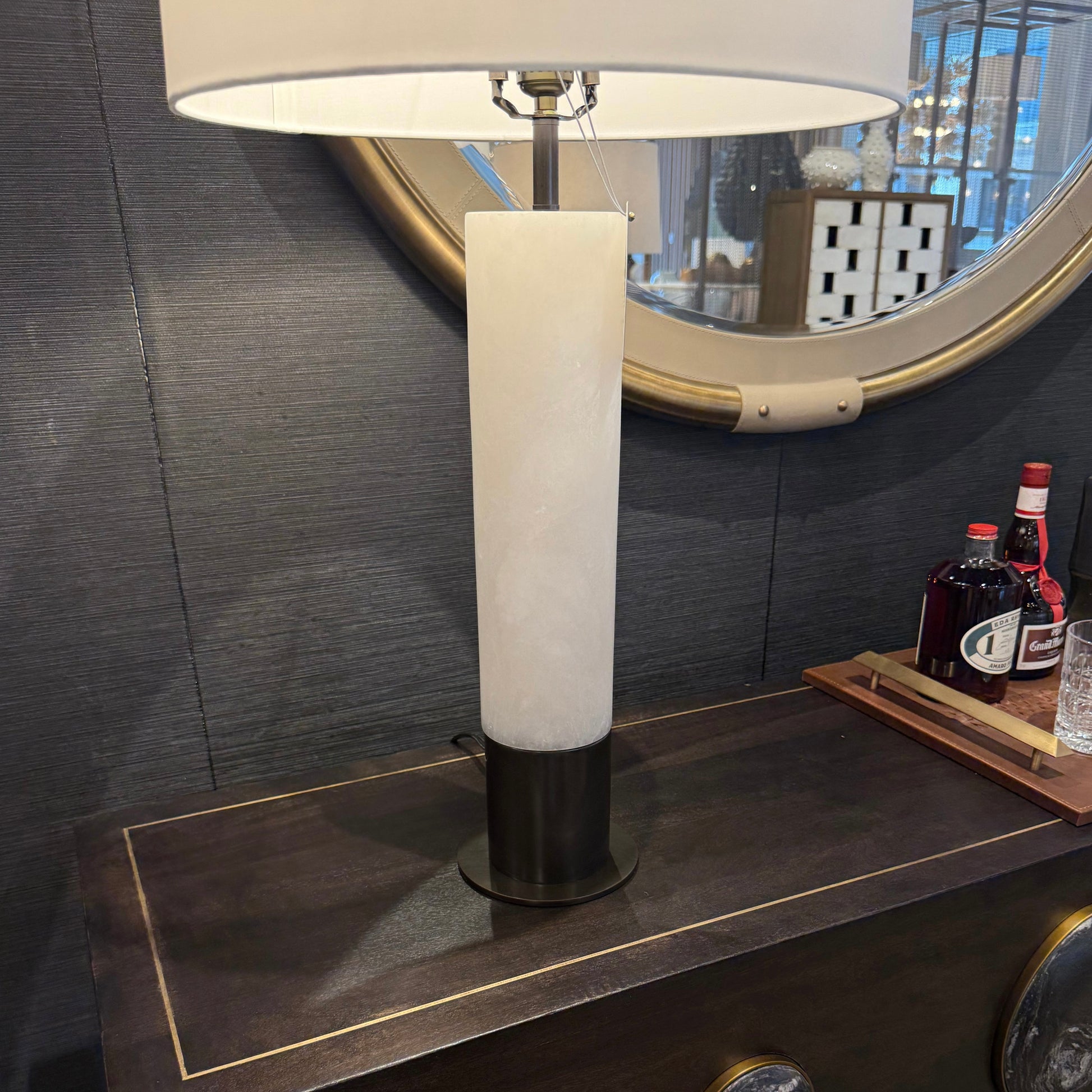 Modern table lamp with marble base on a dark surface
