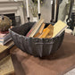 Decorative metal bowl with books on a wooden surface in a home setting