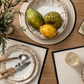 Five-piece flatware set with polished silver metal heads and warm brown wooden handles