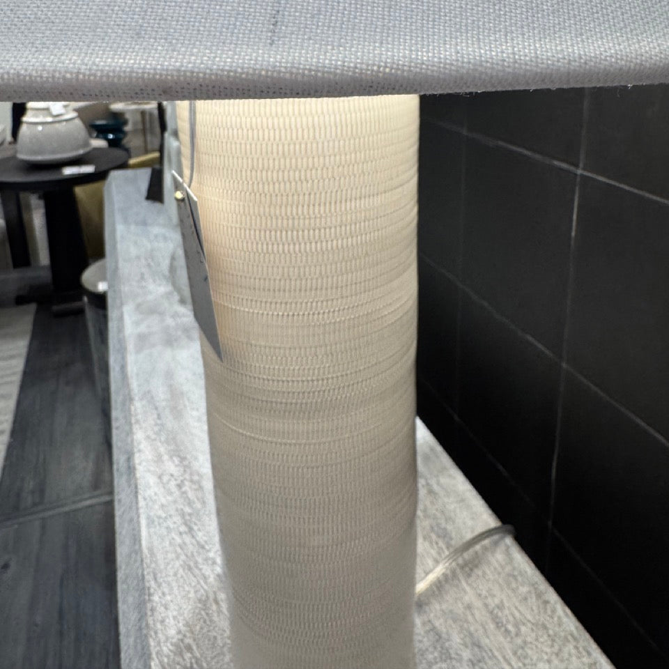 Gray countertop with a textured white column in a modern interior setting