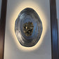 Decorative wall sconce with a textured design on a neutral background