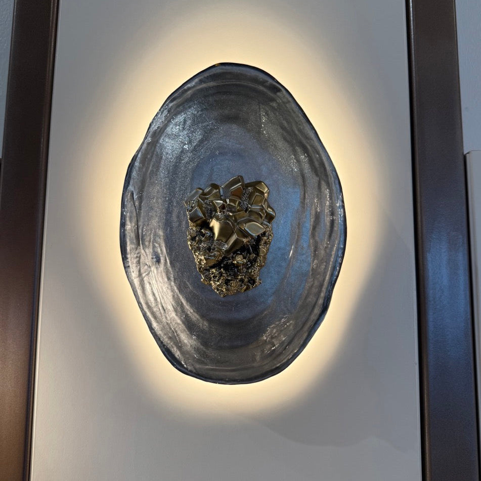 Decorative wall sconce with a textured design on a neutral background