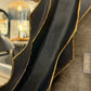 Black mirror with gold trim in a store setting