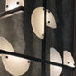Close-up of a modern wall light fixture with circular glass shades.