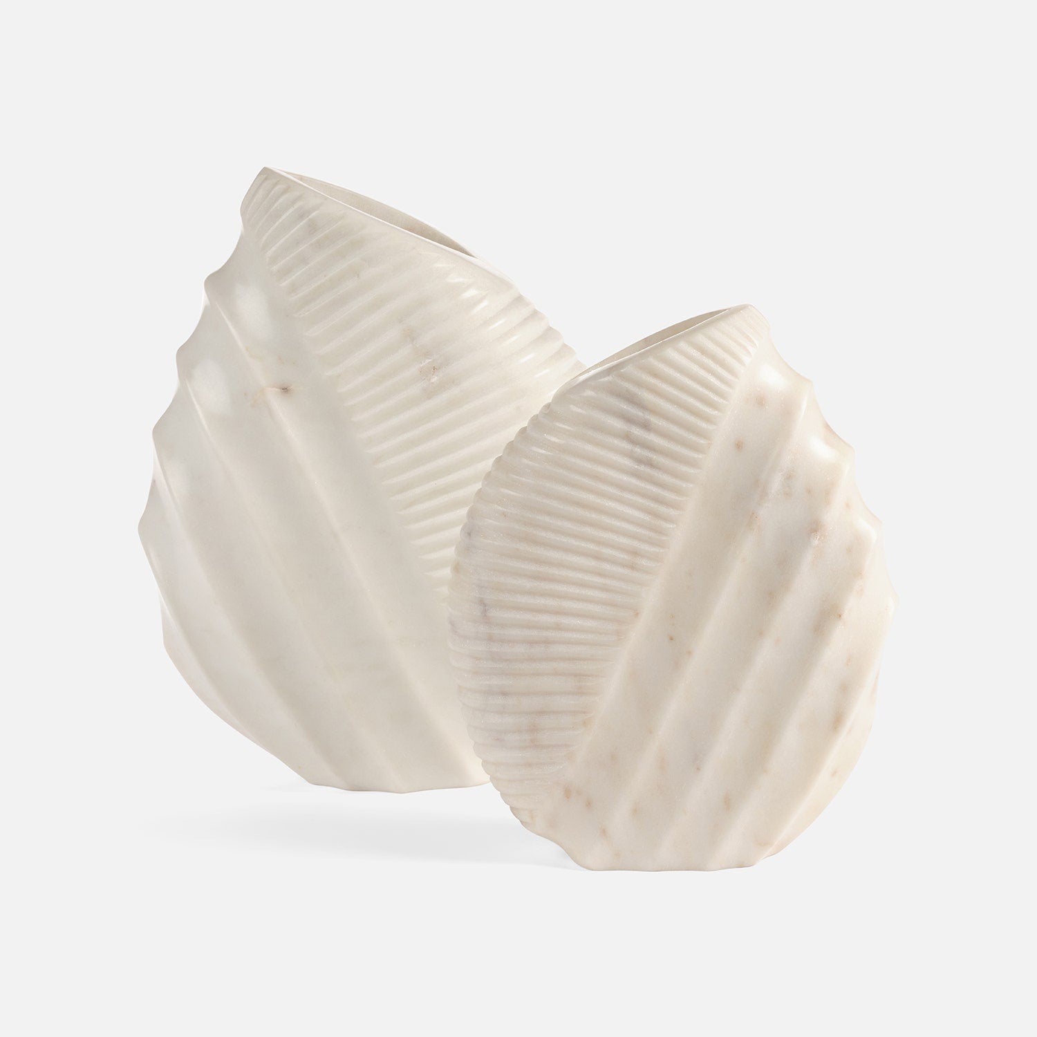 Two white ceramic bowls with textured surfaces on a light gray background