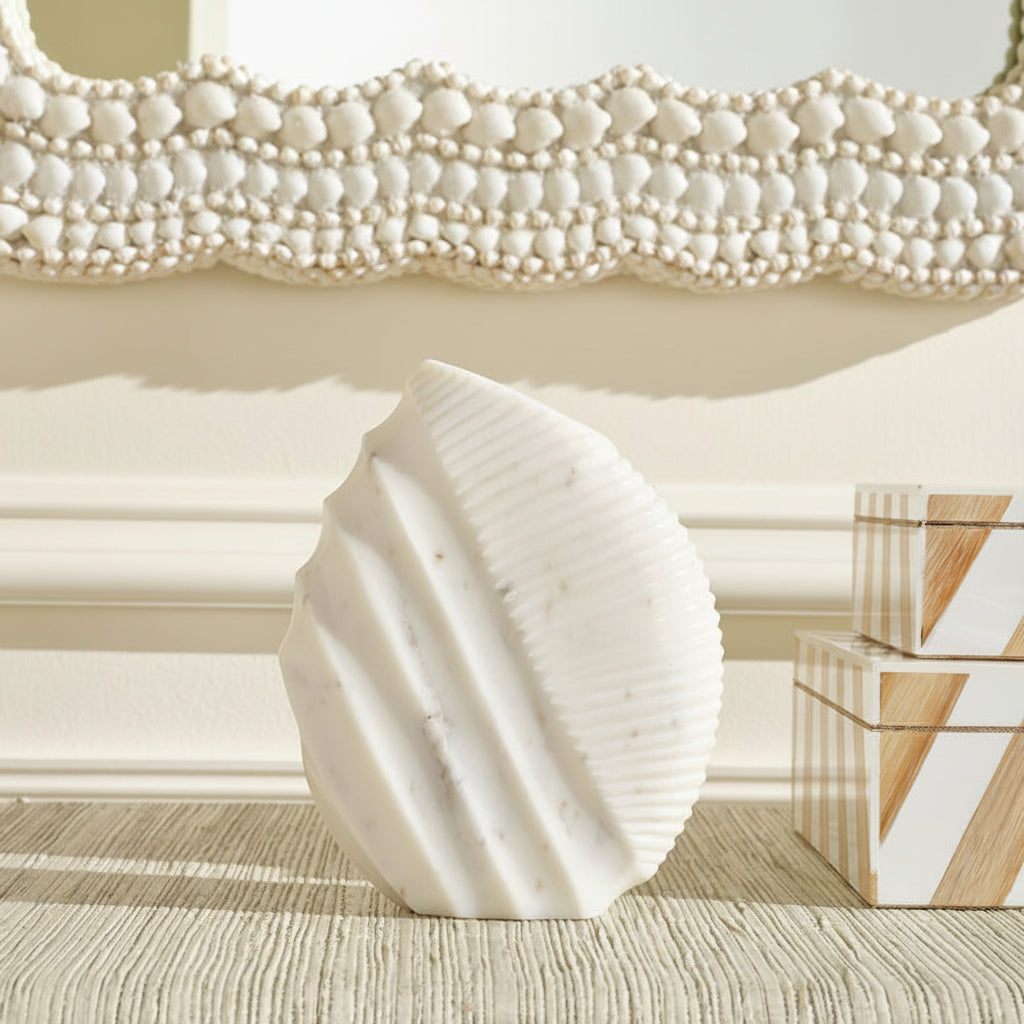 White ceramic vase with flowers on a textured surface