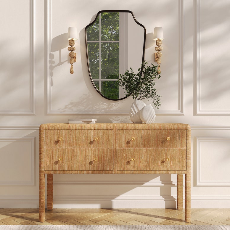 Wooden console table with a mirror and decorative items in a stylish room.