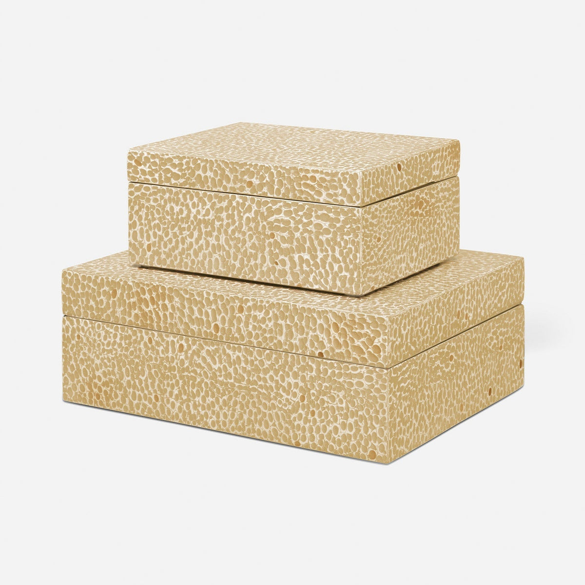 Two nested rectangular storage boxes with lids, featuring a textured beige and cream pebbled or reptile-scale pattern, shown on a light gray background.