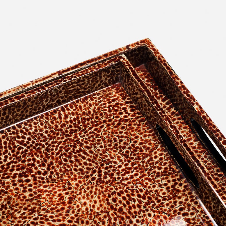 Close-up of a rectangular tray with a glossy leopard print pattern in brown, tan, and black, shown on a light gray background.
