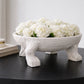 Decorative bowl with white flowers on a dark surface