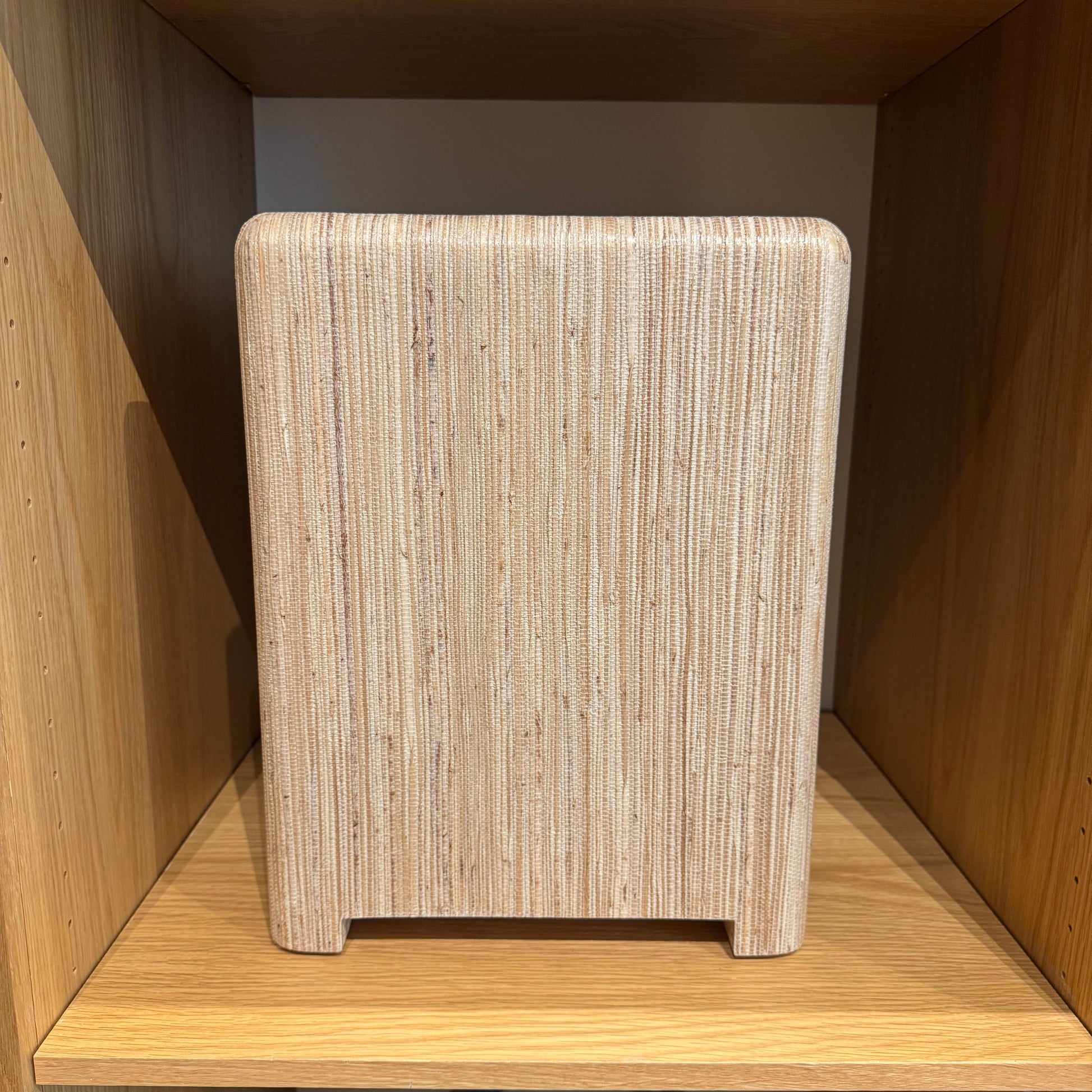 Wooden stool with woven seat in a wooden cabinet setting