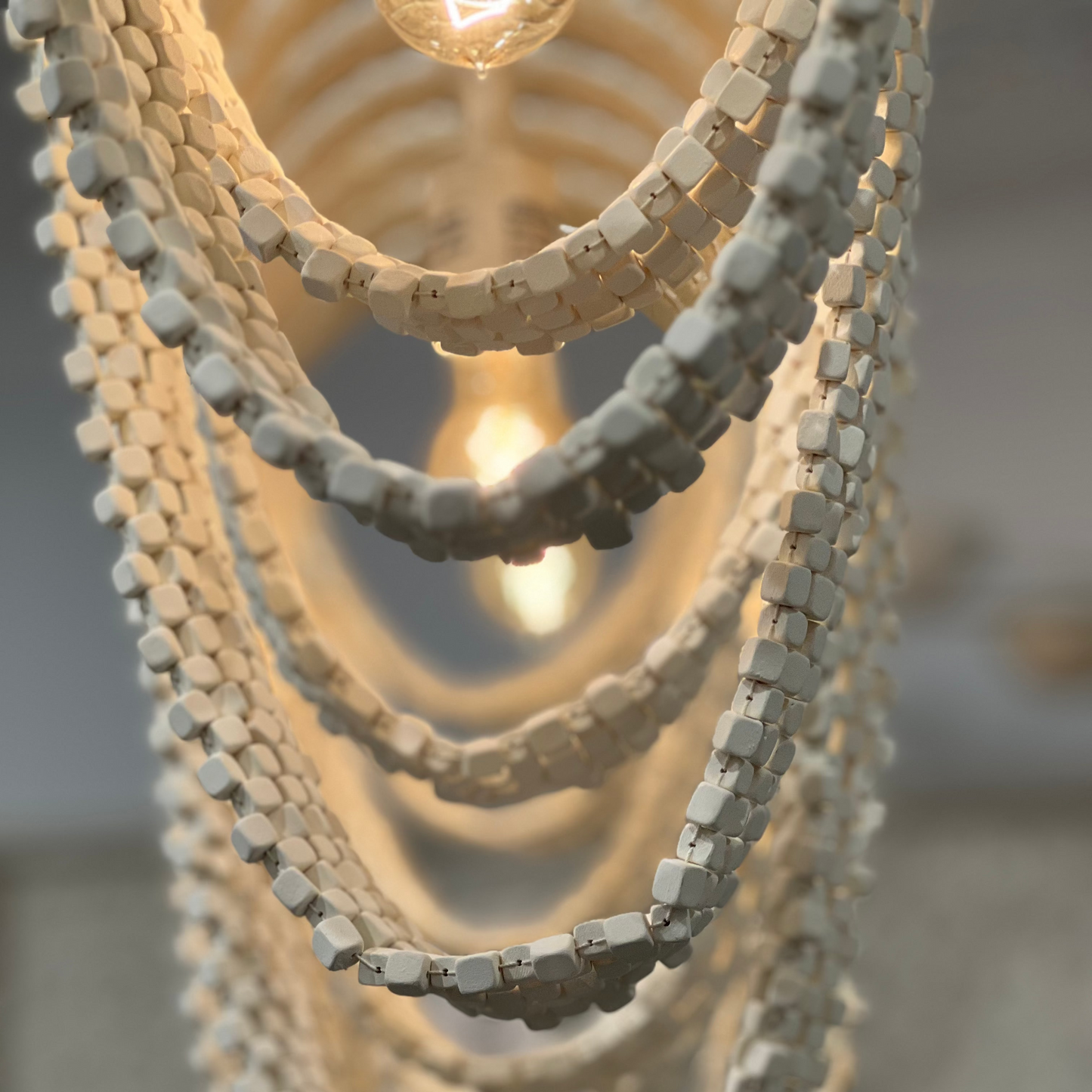 Close-up of a textured pendant light fixture with multiple layers.