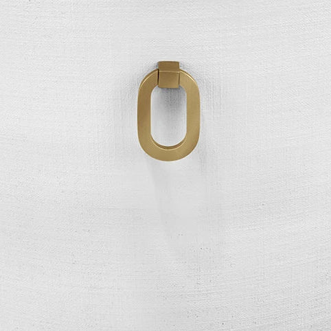 Gold door handle on a white textured surface