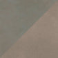 A close-up of a textured surface split diagonally into two tones: a muted sage green on the upper left and a warm taupe-beige on the lower right.