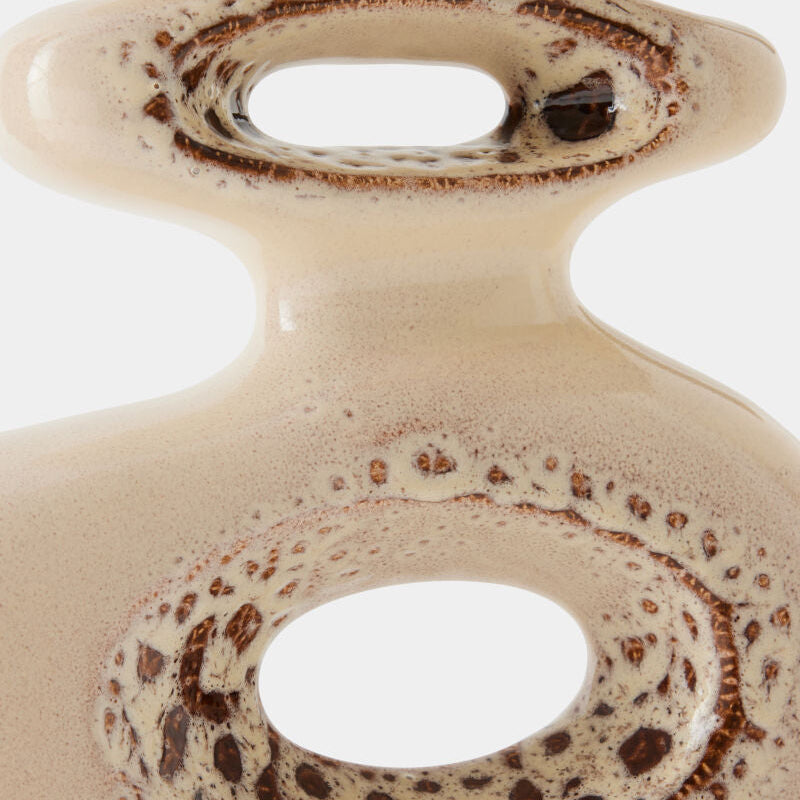 Close-up of a ceramic object with brown speckles on a white background