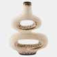 Decorative ceramic vase with a textured surface on a white background