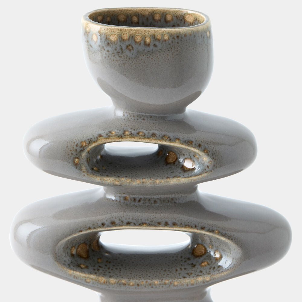 A ceramic sculptural vase with a stacked, tiered design featuring a small rounded top, a wide middle oval ring, and a larger bottom oval ring, all in a glossy gray glaze with metallic gold speckled accents, shown against a plain white background.