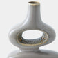 Close-up of a ceramic vase with a glossy light gray glaze and small gold speckled accents around the ring handle, shown against a plain light background.