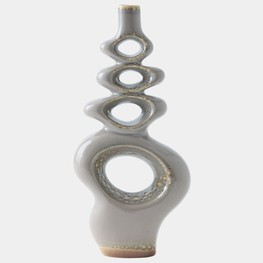 An abstract ceramic vase with a glossy light gray glaze and metallic gold speckled accents, featuring a stacked spiral design on a plain light gray background.